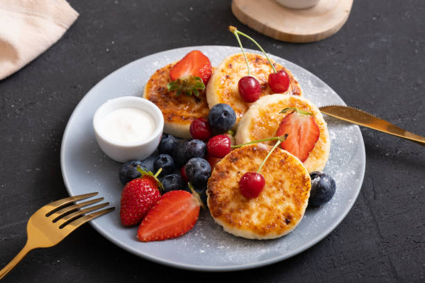 istock Close-up roasted cheesecakes on a plate with powdered sugar and berries angle view 1402485827