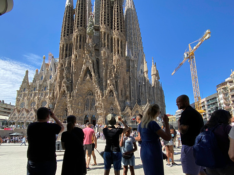 Barcelona, Spain, - May 22, 2022.Tourists photographing the Segrada Famila in the city of Barcelona.