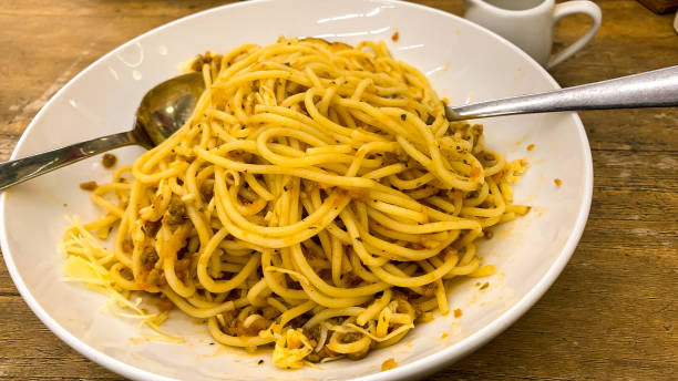 istock Spaghetti with Bolognas sauce on a white plate. on the kitchen table 1402488069