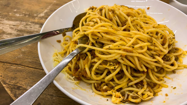istock Spaghetti with Bolognas sauce on a white plate. on the kitchen table 1402488080
