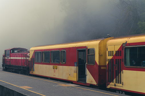 Kelantan, Malaysia - 21 FEBRUARY 2022 : Train stopped in Gua musang station during foggy morning before continuing journey to the next station.