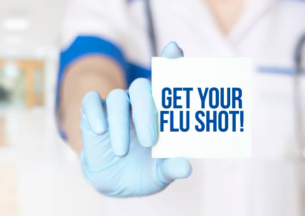 Get Your Flu Shot text on card in hands of doctor close up Get Your Flu Shot text on card in hands of doctor close up flu vaccine photos stock pictures, royalty-free photos & images