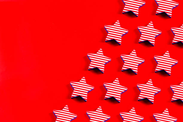July 4th. USA flags color star shape  pattern on red background with copy space.