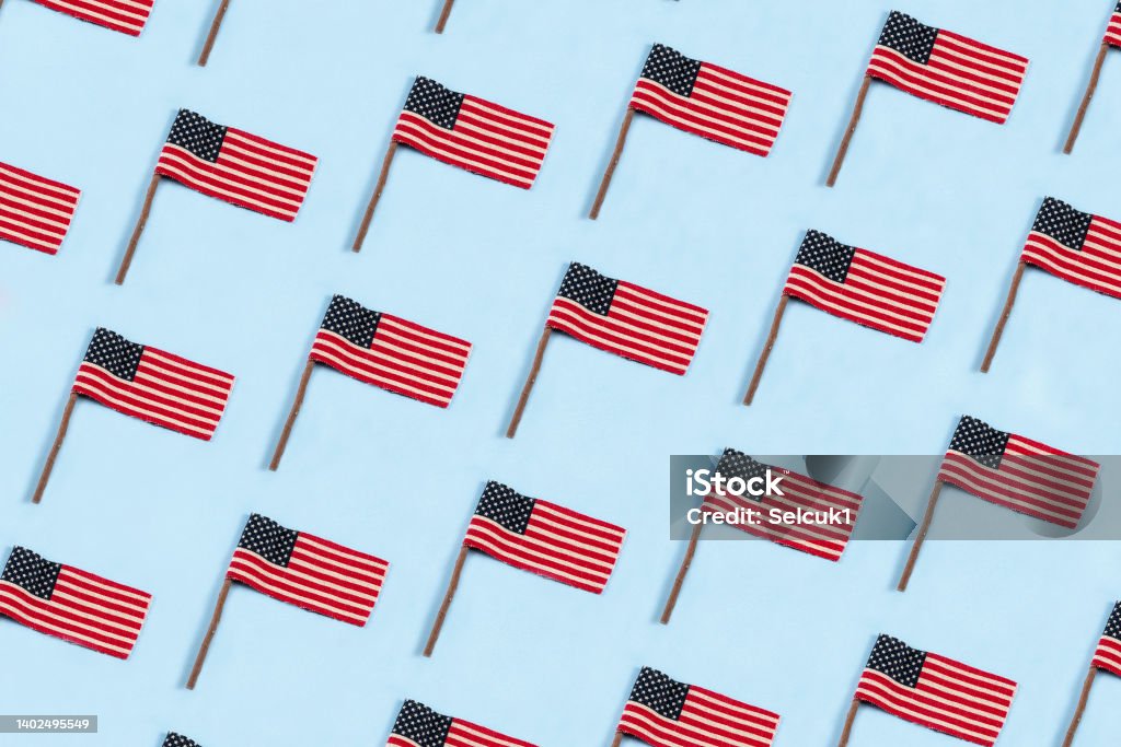 independece Day of USA. July 4th. USA flags pattern on blue background with copy space. Seamless Pattern Stock Photo