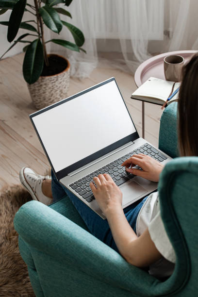 istock Young woman using laptop screen mockup to work home, remote work 1402495579