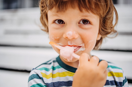 Close-up  kid eating ice cream in summer