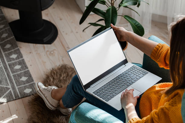 istock Young woman using laptop screen mockup to work home, remote work 1402498142