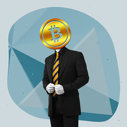 A young businessman in a black business suit and striped yellow tie headed by symbol digital money Bitcoin coin standing on a blue graphic background. Crypto currency. Contemporary art. Modern design