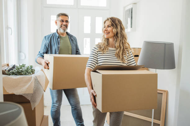 istock Mature Couple with Moving Boxes in New Home 1402501016