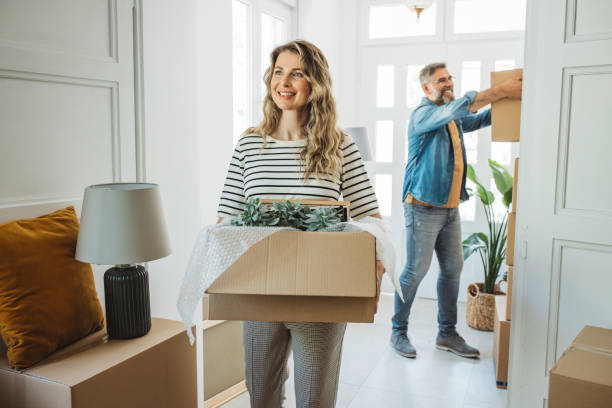 istock Mature Couple with Moving Boxes in New Home 1402501042