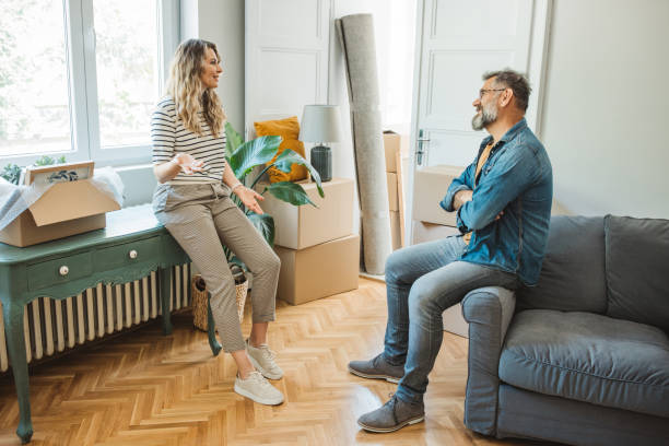 istock Mature Couple with Moving Boxes in New Home 1402501051