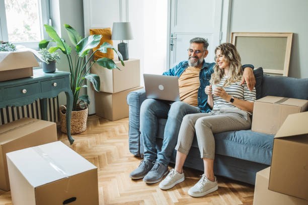 istock Mature Couple with Moving Boxes in New Home 1402501613