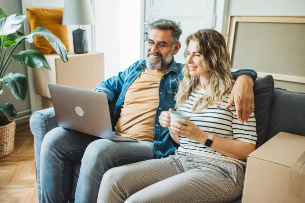 istock Mature Couple with Moving Boxes in New Home 1402501614