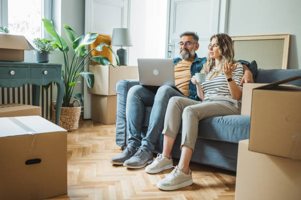 Mature Couple with Moving Boxes in New Home stock photo