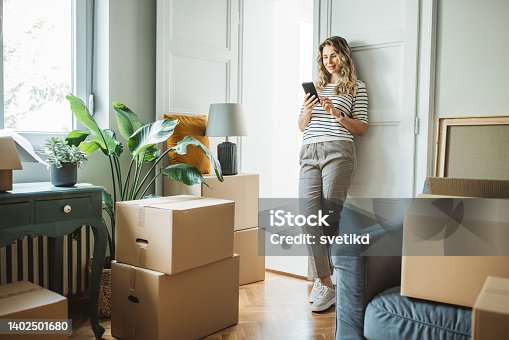 istock Mature woman with Moving Boxes in New Home 1402501680