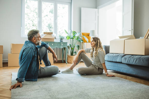 istock Mature Couple with Moving Boxes in New Home 1402501746