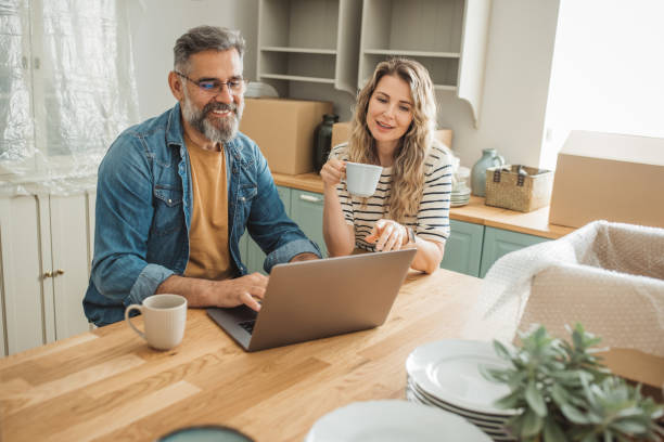 istock Mature Couple with Moving Boxes in New Home 1402501758