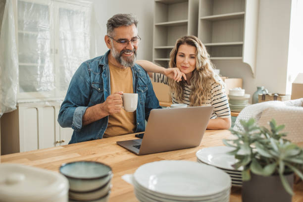 istock Mature Couple with Moving Boxes in New Home 1402501768