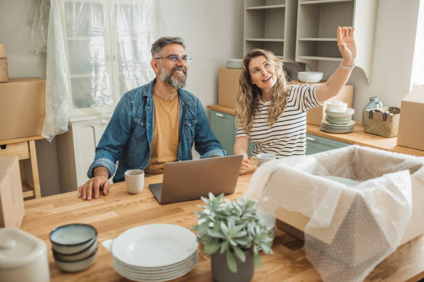 istock Mature Couple with Moving Boxes in New Home 1402501772