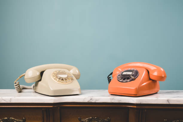 istock View of two old telephones on a table. 1402504370