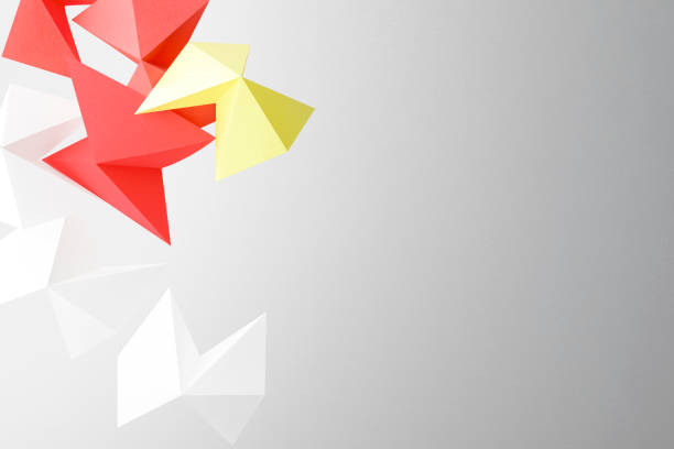 Colorful shapes made paper isolated on gray background