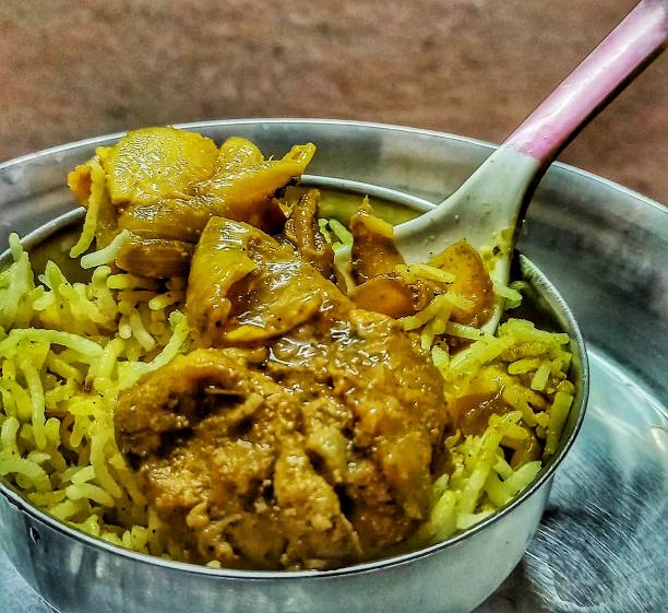 istock biryani served in pot with spoon 1402506695