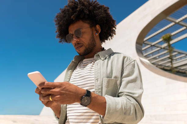 istock African American man using phone outdoors 1402508940