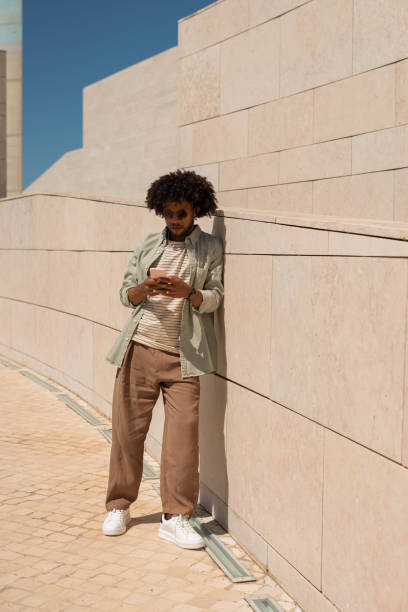 istock Handsome African American man using phone outdoors 1402508977
