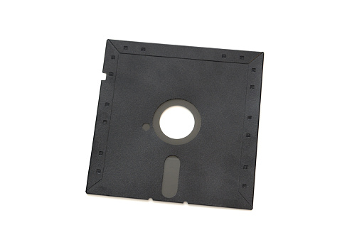 Closeup of a retro floppy disk from the 1980s on a white background.