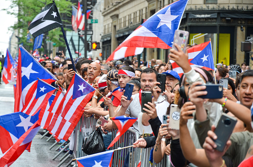 Despite the rain, spectators gathered in Mid-Manhattan to celebrate the 65th annual Puerto Rican Day Parade on June 12, 2022 in New York City.