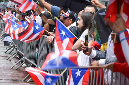Despite the rain, spectators gathered in Mid-Manhattan to celebrate the 65th annual Puerto Rican Day Parade on June 12, 2022 in New York City.