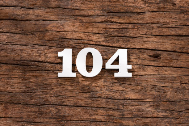 istock Number 104 - piece on rustic wood background 1402511164