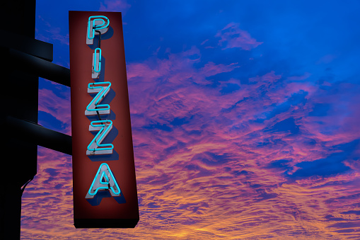 Retro Neon Pizza Sign Against An Amazing Sunset, With Copy Space