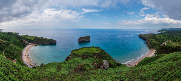 Panoramic view from the Boriza viewpoint of the Andrin and Ballota beaches, with the Castro Ballota rock in the middle, Llanes.