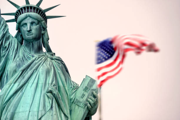 istock Statue of Liberty and American flag 1402514613