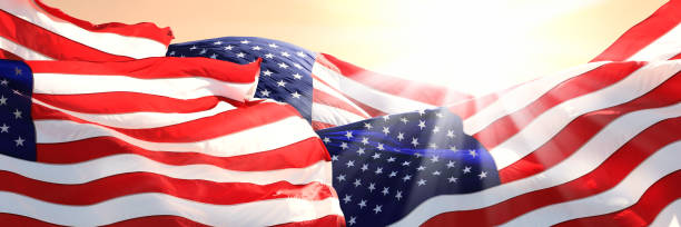 istock Close up group of American flags and sunlight 1402515215