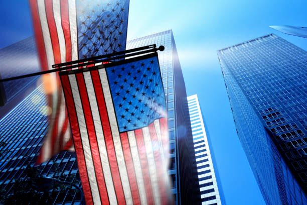 istock Close up shiny American flags and skyscrapers 1402515462