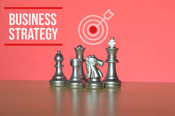 Chess pieces and target symbol with text BUSINESS STRATEGY