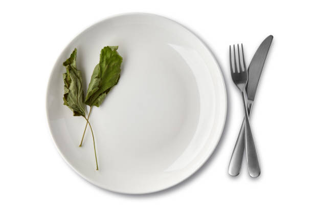 istock White ceramic plate dish decorated with dried currant leaves with cutlery 1402516741