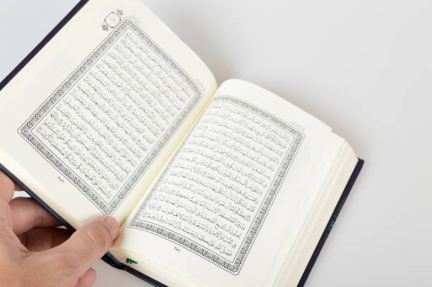 istock Holy Al Quran with written in arabic calligraphy isolated on a white background 1402518018