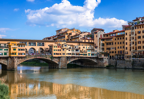 Ponte Vecchio (old Bridge) in Florence, Tuscany, Italy. This medieval stone bridge that spans river Arno, consists of three segmental arches and it has always hosted shops and merchants.