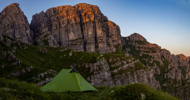 istock green camping tent with mountains background at sunset 1402520269