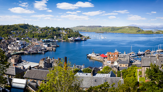 Holidays in Scotland -  panoramic view of Oban on the west coast of Scotland with the town, ferry terminals and hills in the background