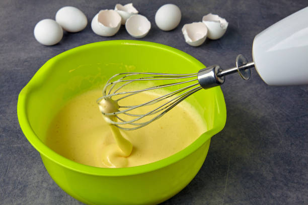 istock Beaten eggs with sugar in a green bowl and a whisk 1402523794