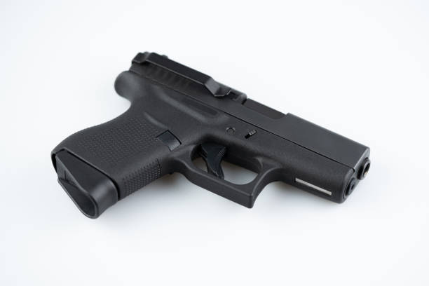istock Modern self loading pistol isolated on white background. Semi automatic gun with belt clip 1402523913