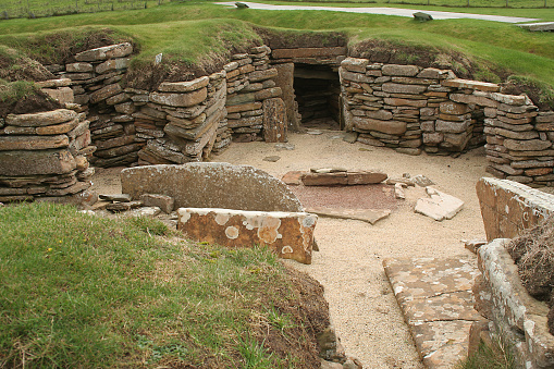 The entrance to, and one of the dwellings at Skara Brae, neolithic settlement, Orkney islands, Scotland