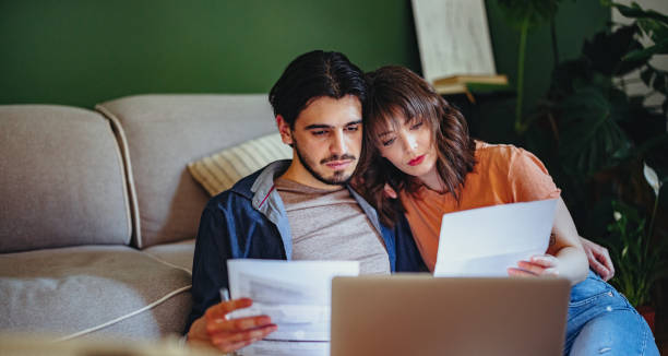 istock Serious Couple Paying Bills at Home 1402529426