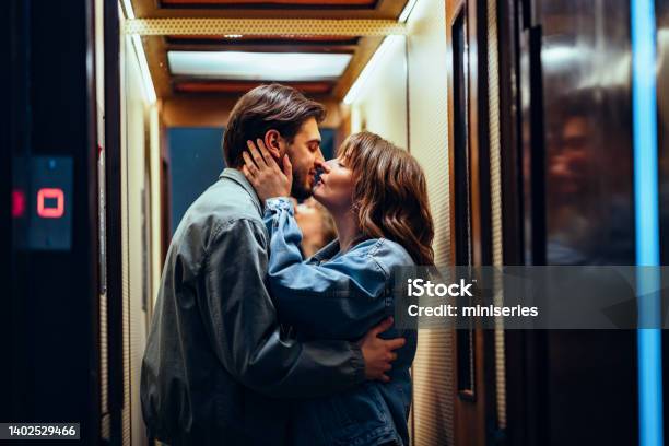 Happy Couple Kissing In The Elevator Stock Photo - Download Image Now - Couple - Relationship, Kissing, Love - Emotion