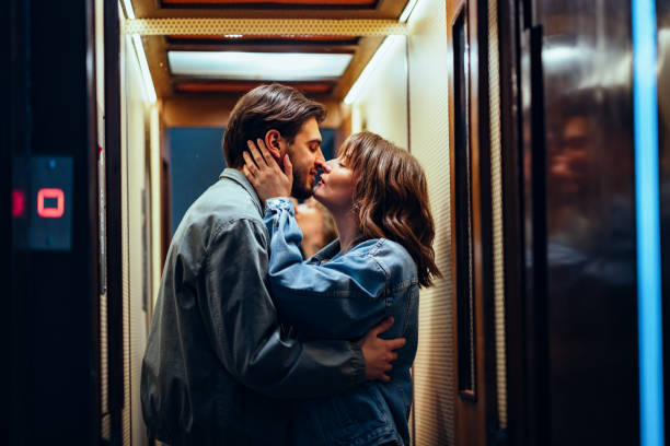 happy couple kissing in the elevator - couple sensuality passion embracing imagens e fotografias de stock