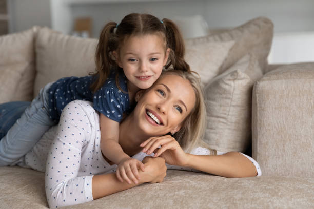 istock Smiling beautiful young mother holding on back adorable kid. 1402529835